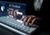 Person typing on a keyboard with a digital AI chatbot interface displayed