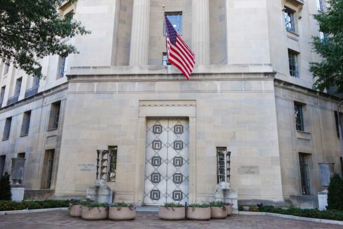 Department,Of,Justice,Building,-,Washington,D.c.,United,States,Of Facade of a government building featuring the American flag and decorative entrance
