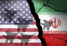 Iran Strike HALTED: Gulf Leaders Intervene A cracked wall featuring the flags of the USA and Iran with military aircraft silhouettes