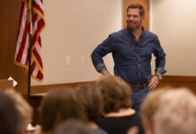 A speaker engaging with an audience in a professional setting