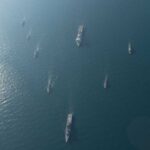 Naval Blockade SHOCKS Iran: Economic Collapse Looms Aerial view of multiple naval ships navigating in the ocean