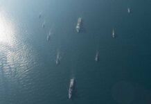 Naval Blockade SHOCKS Iran: Economic Collapse Looms Aerial view of multiple naval ships navigating in the ocean