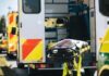 Two Trains, One Track — Unthinkable Failure Ambulance with open rear doors and an empty stretcher outside