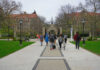 Character Smear Derails Aspiring Lawyer Students walking along a pathway on a university campus with historic buildings in the background