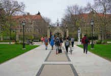 Character Smear Derails Aspiring Lawyer Students walking along a pathway on a university campus with historic buildings in the background