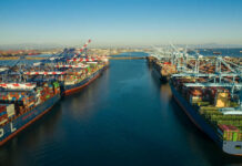 Foreign Fleets Cash In, Americans Benched Aerial view of cargo ships docked at a shipping port