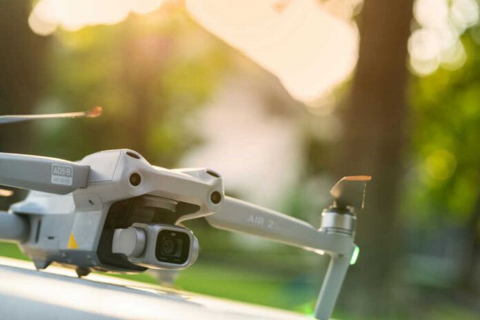 shutterstock1957047103jpg Close-up of a drone with a camera, set against a blurred outdoor background