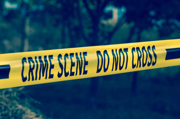 shutterstock710989156jpg Yellow crime scene tape reading DO NOT CROSS