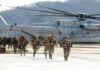 ISIS Boss Hit — But Numbers Don’t Add Up Marines in combat gear walking towards a helicopter