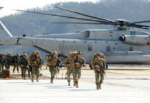 ISIS Boss Hit — But Numbers Don’t Add Up Marines in combat gear walking towards a helicopter