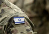 Survival Doctrine Drives Israel’s Strikes Close-up of a military uniform with an Israeli flag patch