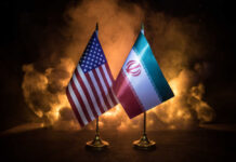 Vance’s Swiss Whiplash Stuns Washington Flags of the United States and Iran displayed together