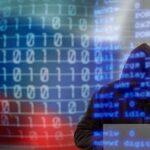 Chinese Spy Job Boards Exposed A hooded figure working on a laptop with binary code in the background