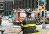 Firefighter Arson Twist Stuns Town Firefighter in FDNY uniform overseeing emergency response at a city intersection