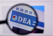 Laptop Shock: Truth Buried, Timing Weaponized Magnified view of a website header featuring the acronym 'DEA' and social media icons