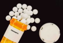 DEA Watched Fentanyl Flow — On Purpose? Prescription bottle of fentanyl with white pills scattered around