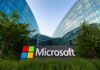 Microsoft sign in front of a modern glass building