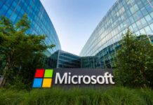 Microsoft sign in front of a modern glass building