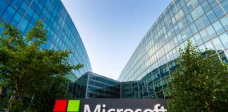 Microsoft sign in front of a modern glass building