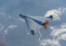 A drone flying high above the clouds with a visible propeller