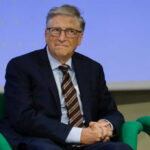 Closed-Door Gates Testimony Sparks Outrage A man in a suit sitting on a green chair during a conference