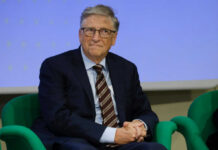 Closed-Door Gates Testimony Sparks Outrage A man in a suit sitting on a green chair during a conference