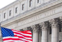 SCOTUS Smacks Down Trump’s Citizenship Gambit Facade of a United States courthouse with an American flag in the foreground