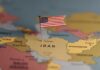 Deal Or Bluff? Iran Drama Escalates A map highlighting Iran with a small American flag pin