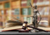 Appeals Bombshell Freezes Alabama Execution A gavel and a statue of Lady Justice beside an open law book
