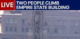 LIVE: People climb to top of Empire State Building spire for flag-raising proposal