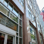 Washington’s Time Bomb: Benefits Axed 22% Exterior view of the United States Social Security Administration building with flags