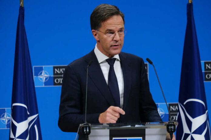 shutterstock2524491697jpg A government official speaking at a NATO press briefing