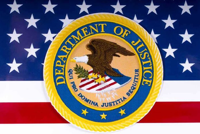 shutterstock_1054857686 Department of Justice seal on American flag background