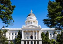 Hospitals Exposed: Retroactive Claims Unleashed State capitol building with white dome and columns framed by trees