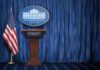 High-Stakes Tuesday: Trump, Netanyahu Lock In White House press briefing podium with U.S. flag and blue curtain