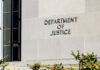 54-Minute Firing Ignites DC Power Brawl Sign on the exterior wall of the Department of Justice building
