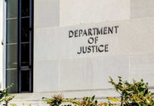 54-Minute Firing Ignites DC Power Brawl Sign on the exterior wall of the Department of Justice building