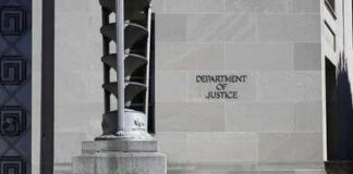 Department of Justice building exterior with stone facade and plants