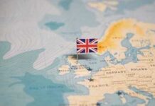 A map of Europe with a small flag of the United Kingdom pinned on it