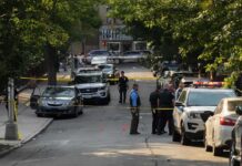 Terrifying Threat Targets Governor’s Kids Police officers secure a residential street with patrol cars and yellow tape