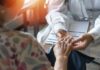 France’s Chilling New Line: Who Decides Life? A doctor holding the hand of an elderly patient during a consultation