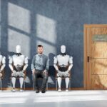 Dutch Hub Quietly Arms The Robots A man sitting between three humanoid robots in a waiting room for a job interview