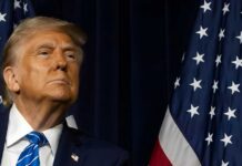 Trump’s Diesel Do-Over Sparks Fury A political figure looking upward beside an American flag