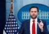 Podcast Confession Rattles Washington Government official speaking at a press conference in front of the White House