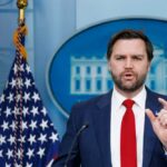 Podcast Confession Rattles Washington Government official speaking at a press conference in front of the White House