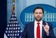 Podcast Confession Rattles Washington Government official speaking at a press conference in front of the White House