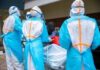 Ebola Money Vanishes — Deaths Soar Medical workers in PPE assist a patient on a stretcher outdoors