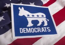 Progressive Brand Bomb Threatens Dems Democrats donkey symbol on a blue sign over an American flag