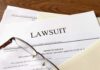 Legal documents labeled lawsuit on a desk