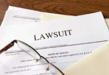 Legal documents labeled lawsuit on a desk